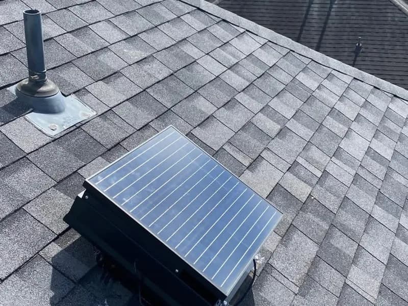 Close up of an installed solar attic fan on a residential roof